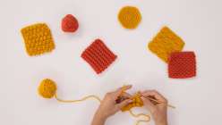 Hands crocheting with two colors of yarn for Creativebug