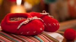 A pair of red felted Lil' tootsie slippers from Maggie Pace's Creativebug class