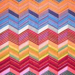 In this workshop, Kaffe Fassett talks about how to work within a rich color palette to create a light-dark zig-zag illusion, as well as how to work with solids and striped fabrics to create motifs from diamond shapes. 