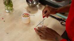 A pair of hands making a candle from Arina Soler's Handmade Candles class on Creativebug.