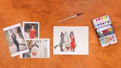 An overhead image of a monoprinted picture of three children trick-or-treating made with acrylic ink and watercolor.