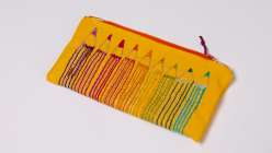 A colorful pouch embroidered with multicolored pencils made by Rebecca Ringquist in her Embroidered Pencil Case class on Creativebug