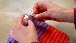 Two hands crocheting a rib stitch from Cal Patch's Crocheted Ribbed Socks class on Creativebug