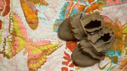 Anna Maria Horner teaches you the entire process of creating a baby quilt, from laying out and basting, then highlighting the design of a printed fabric with even stitching, and finally binding the quilt with single fold bias binding.