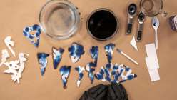 Blue and white paper snowflakes made in Mia Semingson's Make Shibori-Inspired Paper Snowflakes class on Creativebug