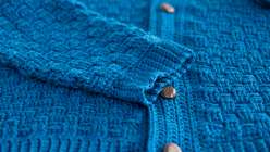 A blue crocheted sweater made by Tian Connaughton in her Crochet the Harrison Sweater class on Creativebug