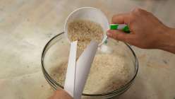 A scooper of rice pouring into a handmade heating pad sewn in A handmade heating pad made in Sanae Ishida's Sew a Heating Pad Creativebug class