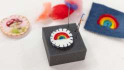A rainbow patch being needle felted in Melissa Lang Lyttle's Mending With Wool Felt class on Creativebug.