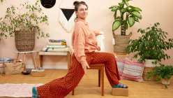 Liza Laird performing a supported yoga posture in her Movement for Makers class on Creativebug