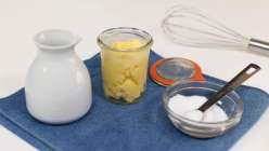 A jar of yellow butter, a bowl of salt, and a pitcher of cream from the Make Homemade Butter class on Creativebug