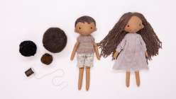 Two handmade rag dolls, a boy and a girl, made in Katia Ferris's Creativebug class Rag Doll Hairstyles: Short and Long.