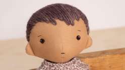 A rag doll with short yarn hair made in Katia Ferris's Creativebug class Rag Doll Hairstyles: Short and Long.