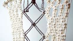 Emily Katz teaches how to make her signature bohemian wall hanging. This artwork is built upon a piece of found driftwood, and uses thick cotton rope and one simple knot to create an overall pattern.