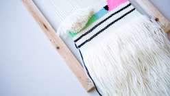 In this weaving class Annabel Wrigley teaches you how to build your own loom using an inexpensive frame and nails, and then demonstrates how to set up the warp threads.